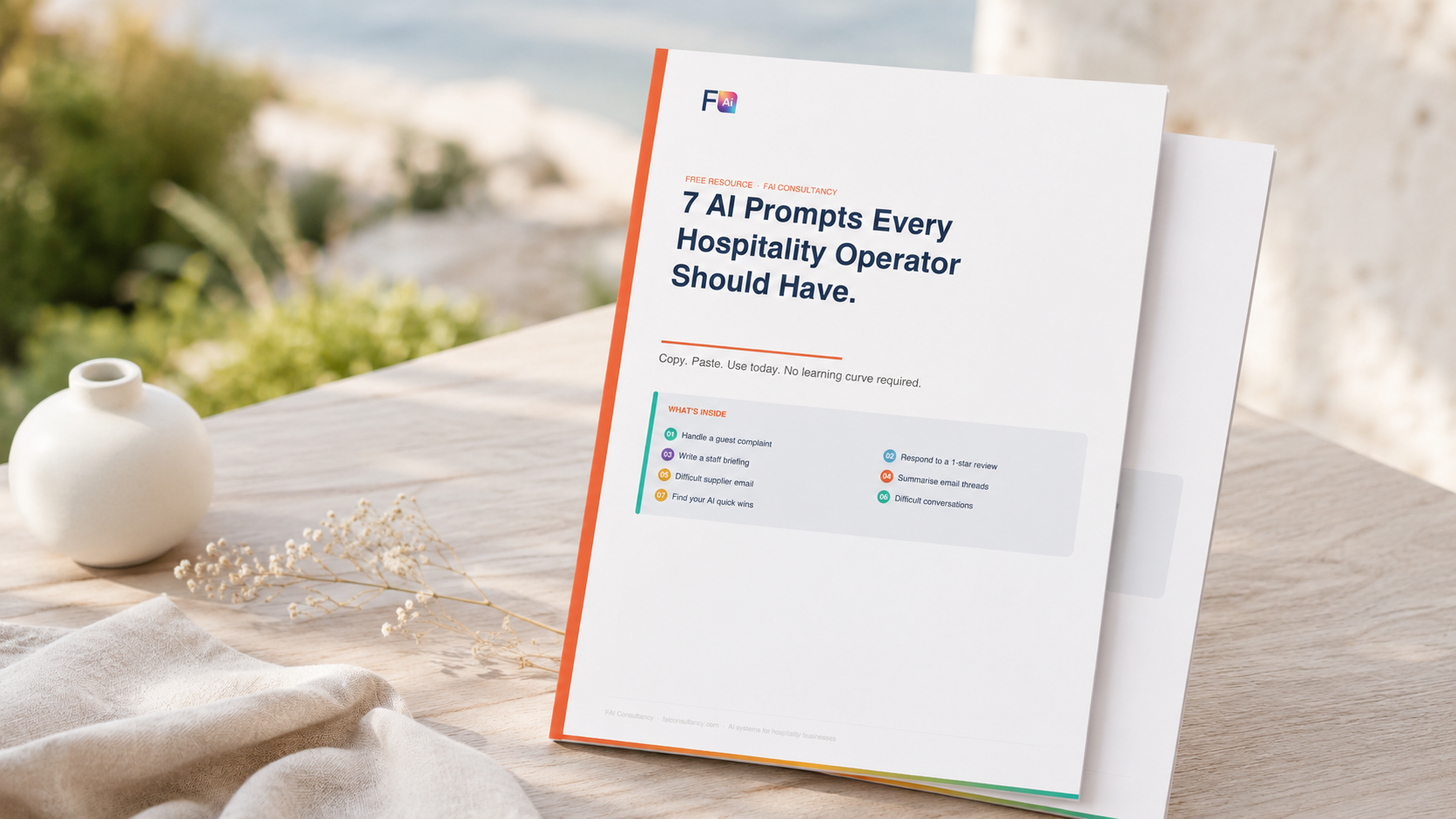 Product mockup of the 7 AI Prompts guide for hospitality operators,  styled on a sun-bleached coastal surface with natural daylight.